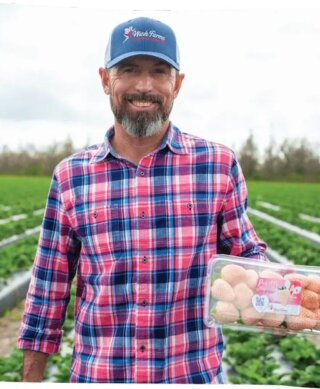 Chris showing a Wish Farms Pineberry